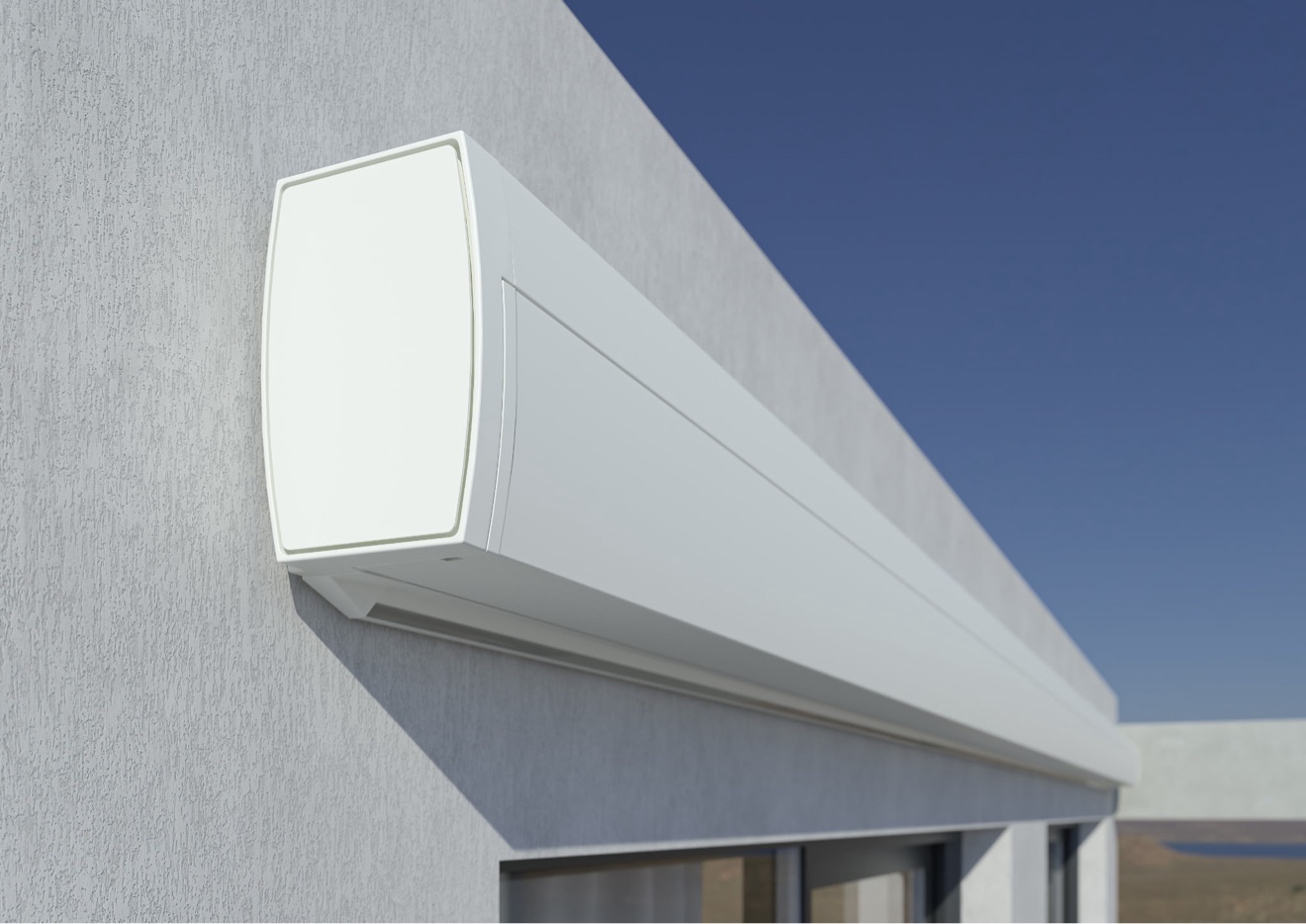 White retractable awning cassette housing close-up against a blue sky